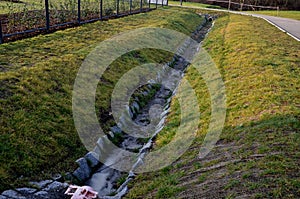 Sewer pipes under the bridge. crossing ditch by side road. concrete hole