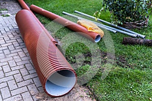 Sewer repair. New, brown plastic culverts