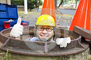 Sewerage worker in the manhole