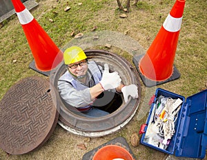 Sewerage worker in the manhole