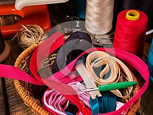 Sewing accessories coil threads and measuring tape in basket supplies