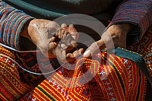 Sewing Black Hmong ethnic textile, Vietnam