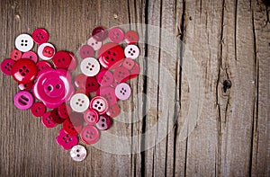 Sewing buttons in the shape of a heart