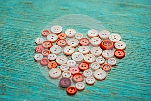 Sewing buttons in the shape of a heart