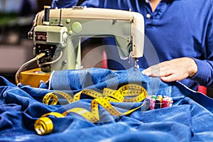 Sewing denim jeans with sewing machine. Repair jeans by sewing machine. Alteration jeans, hemming a pair of jeans, handmade