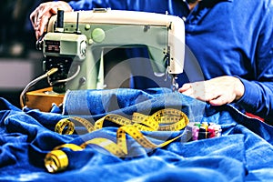 Sewing denim jeans with sewing machine. Repair jeans by sewing machine. Alteration jeans, hemming a pair of jeans, handmade