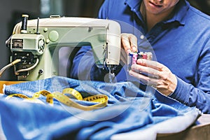 Sewing denim jeans with sewing machine. Repair jeans by sewing machine. Alteration jeans, hemming a pair of jeans, handmade