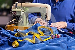 Sewing denim jeans with sewing machine. Repair jeans by sewing machine. Alteration jeans, hemming a pair of jeans, handmade