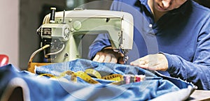 Sewing denim jeans with sewing machine. Repair jeans by sewing machine. Alteration jeans, hemming a pair of jeans, handmade