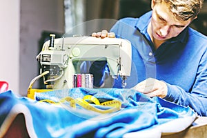 Sewing denim jeans with sewing machine. Repair jeans by sewing machine. Alteration jeans, hemming a pair of jeans, handmade