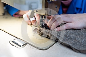 Sewing details of fur and leather. Shoe production