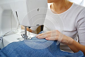 Sewing. Girl sews clothes on a sewing machine