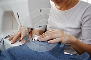 Sewing. Girl sews clothes on a sewing machine