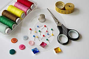 Sewing items on white background