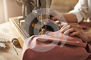 Sewing keeps my mind relaxed. Cropped shot of female tailor working on new project, making clothes with sewing machine