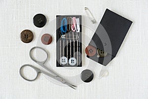 Sewing kit for a traveller top view white linen background