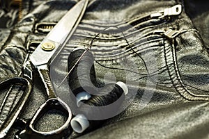 Sewing leather jacket, repair of leather jacket scissors, thread, close-up. Products of leather