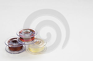 Sewing machine bobbins with thred isolated on whaite background