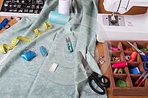 Sewing machine and cloth, set of sewing accessories on table