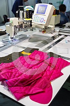 Sewing machine in cutting shop on clothing factory