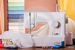 Sewing machine and fabric in work, near sewing accessories