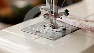 Sewing machine foot. Workplace for sewing and repairing clothes. Needle and thread