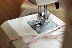 Sewing machine foot. Workplace for sewing and repairing clothes. Needle and thread