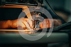 Sewing machine and men`s hands of a tailor