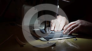 Sewing machine and men's hands of a tailor