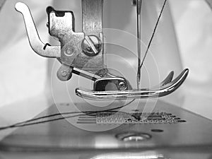 Sewing machine metal foot showing metal feed dogs