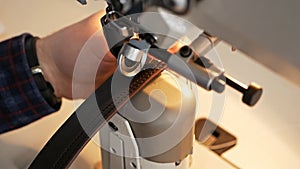 Sewing machine needle in motion. A close-up of the needle of a sewing machine moves quickly up and down. The tailor sews