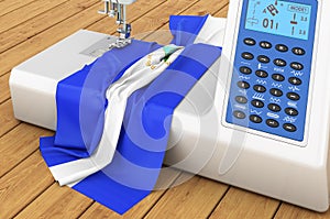Sewing machine with Nicaraguan flag on the wooden table. 3D rendering