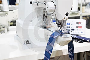 Sewing machine process a seam on jeans fabric