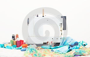 Sewing machine with sewing accessories on table