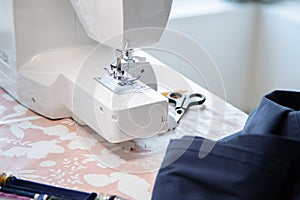 Sewing machine and some accessories, workspace at home or workshop.