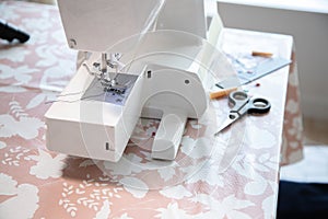 Sewing machine and some accessories, workspace at home or workshop.