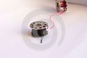 sewing machine steel yarn, bobbin for thread on white background