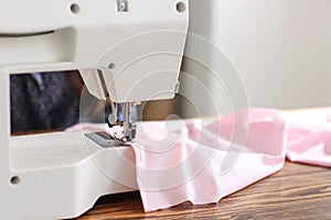 Sewing machine on table in tailor's workshop