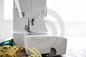 Sewing machine on table in tailor's workshop