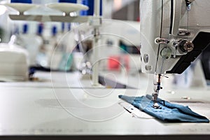 Sewing machine on textile fabric closeup, nobody