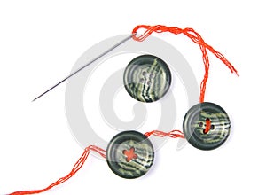 Sewing needle with thread and buttons
