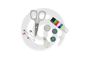 Sewing Needle thread scissors thimble tailor buttons. Closeup top view of sewing tools accessories on white background work place