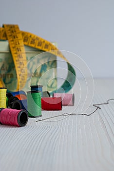 Sewing objects, threads, needle and tape measure