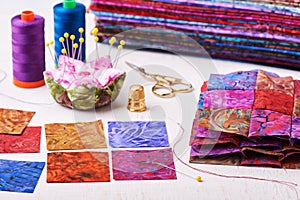 Sewing patchwork blocks to colorful batik quilt