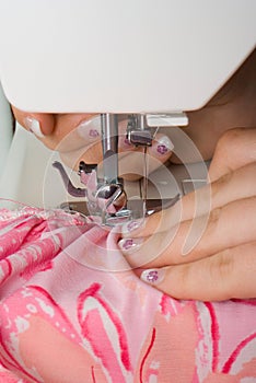 Sewing pink on a machine