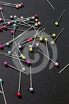 Sewing pins placed on a Black background