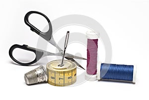 sewing scissors needle thread thimble white background
