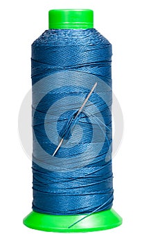 Sewing spool with blue thread and attached needle