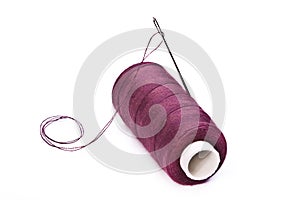 Sewing spool with a needle