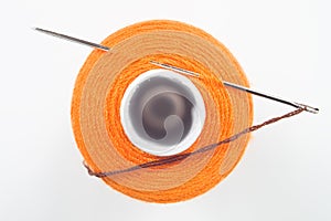 Sewing spool with a needle